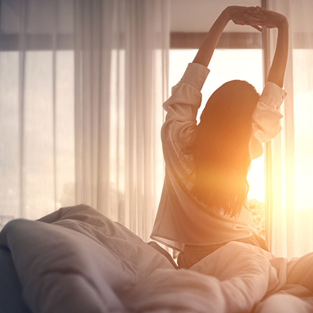 Woman getting out of bed in morning