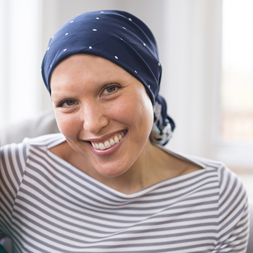 Cancer patient smiling with scarf