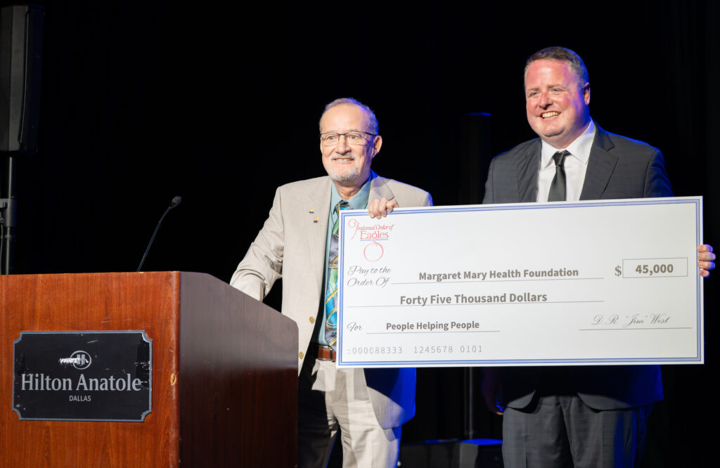 Grand Secretary of the Fraternal Order of Eagles Gary Weber (left) presents a $45,000 grant to Margaret Mary Health Foundation Executive Director Jonathon Maple.